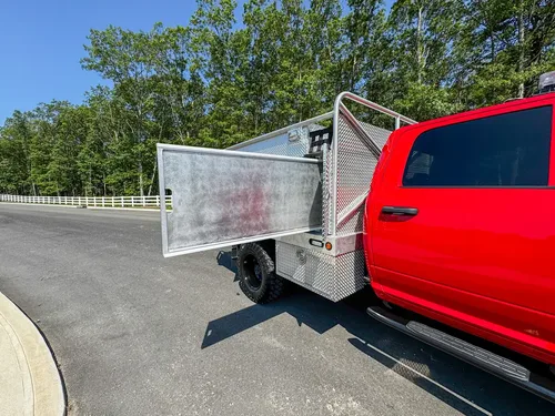 Lower right-side compartment open with fold-down door and interior cavity.